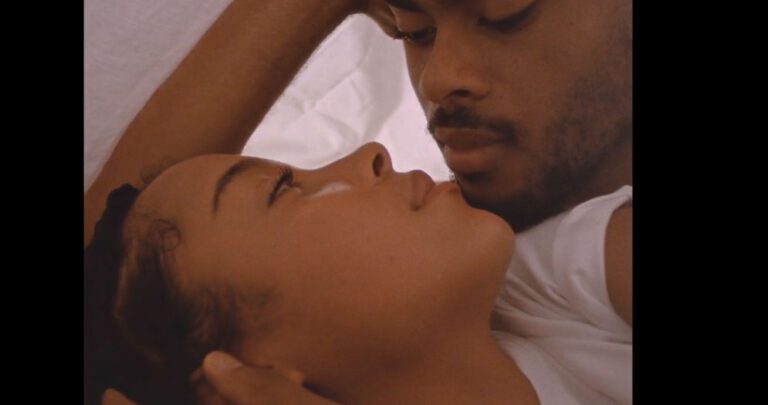 Love Me: a couple look at each other, almost kissing