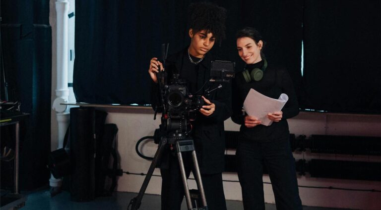 Female porn directors - a woman holding a script talks to another woman behind a camera