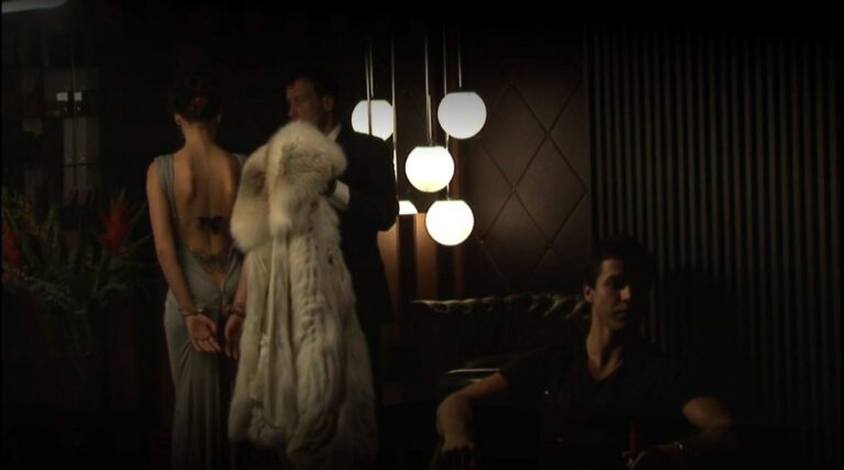 Handcuffs: a man takes off a woman's coat and reveals she's wearing handcuffs