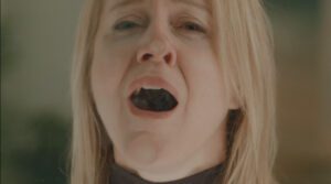 Squeegee - a woman presses herself against glass as she experiences pleasure