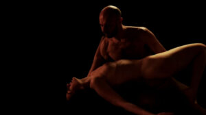 Dancing in the fire - a naked man and woman embrace and dance